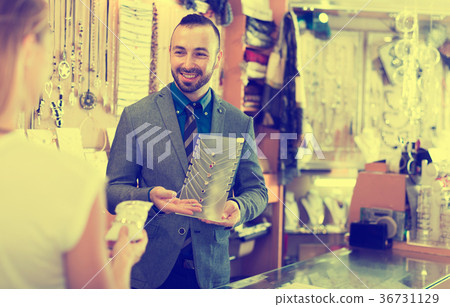Cheerful male offering to buy fashionable necklace 36731129