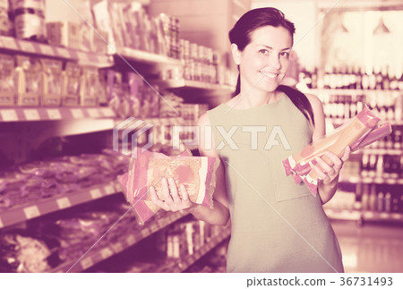 Woman choosing pack of spaghetti 36731493