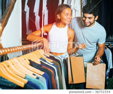 male and female holding colorful dress 36731554
