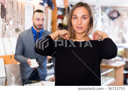 woman choosing chainlet and pendants 36731753
