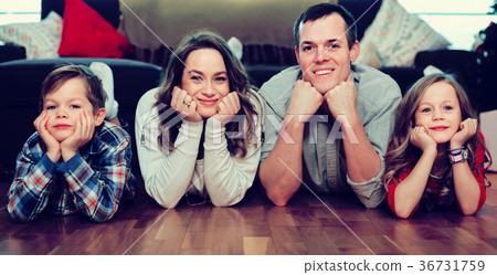 cheerful parents and two kids happy to spend time at home 36731759