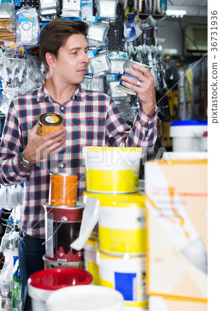 Worker selling tins of paint Worker selling tins of paint 36731936