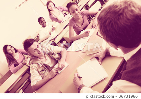 Enthusiastic girls and boys taking the notes while Enthusiastic girls and boys taking the notes while 36731960