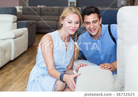 Happy couple are choosing new sofa-transformer 36732025