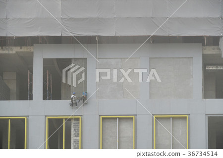 Construction worker abseiling plastering 2 people 36734514