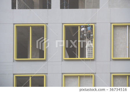 Construction worker abseiling plastering 2 people 36734516