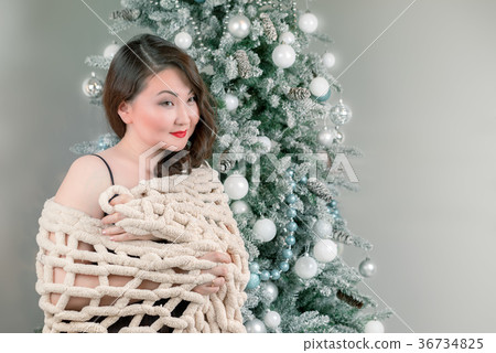 asian woman in shawl near the christmas tree asian woman in shawl near the christmas tree 36734825