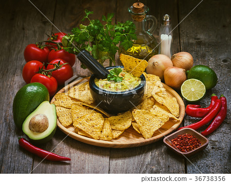 Bowl of delicious homemade Guacamole with nachos Bowl of delicious homemade Guacamole with nachos 36738356