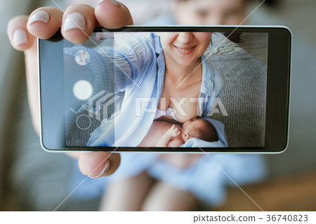 mother breastfeeding mobile photo newborn baby 36740823