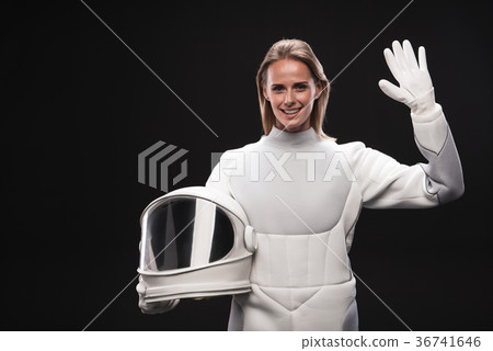 Cheerful lady cosmonaut is welcoming someone Cheerful lady cosmonaut is welcoming someone 36741646