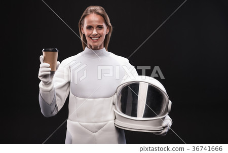 Happy spacewoman is smiling and drinking espresso 36741666