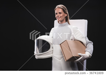 Cheerful woman astronaut is carrying her things 36741809