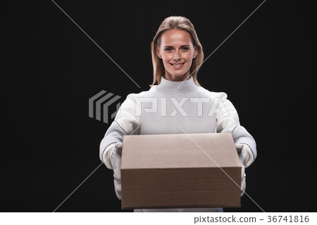 Optimistic happy woman astronaut is keeping carton Optimistic happy woman astronaut is keeping carton 36741816