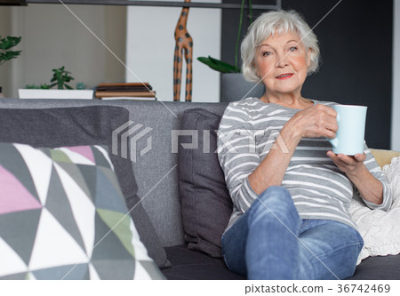 Graceful senior woman resting at home with hot tea 36742469