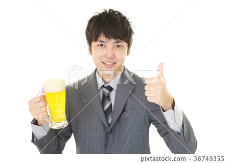 Smiling office worker drinking beer Smiling office worker drinking beer 36749355