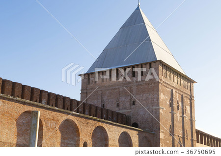 brick old tower with a pointed roof part of wall 36750695
