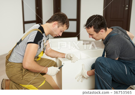 Two mans assembling furniture 36753565