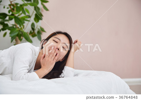 A woman having a relaxing afternoon in bed 36764848