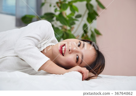 A woman having a relaxing afternoon in bed 36764862