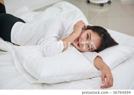 A woman having a relaxing afternoon in bed 36764894
