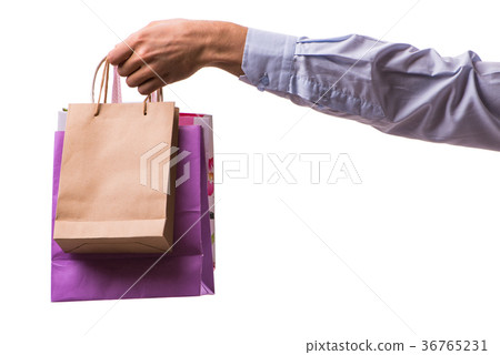 Hand holding shopping bags with christmas shopping Hand holding shopping bags with christmas shopping 36765231