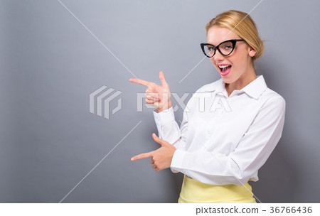 Young woman with a displaying hand gesture  36766436