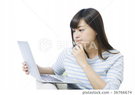 Young woman playing computer on the couch Young woman playing computer on the couch 36766674