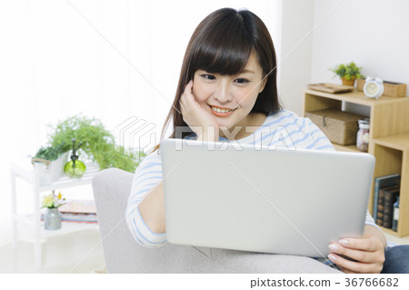 Young woman playing computer on the couch 36766682