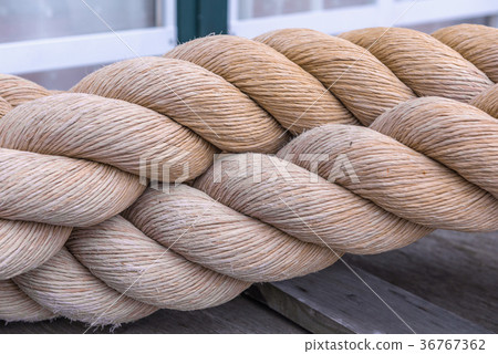 Segments of raw old rope on the floor Segments of raw old rope on the floor 36767362