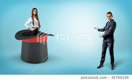 A businessman shows a self-assured businesswoman 36768206