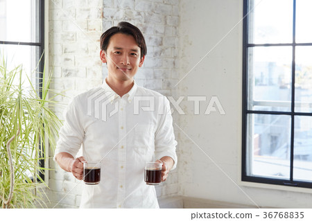 Male hand holding coffee 36768835