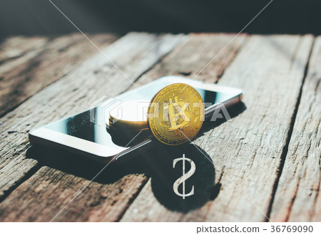 golden bitcoin coin on mobile phone  36769090