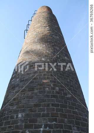 Chimney extending towards the sky Chimney extending towards the sky 36769266