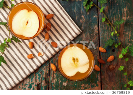 Hot drink of apple tea with cinnamon stick. Hot drink of apple tea with cinnamon stick. 36769819