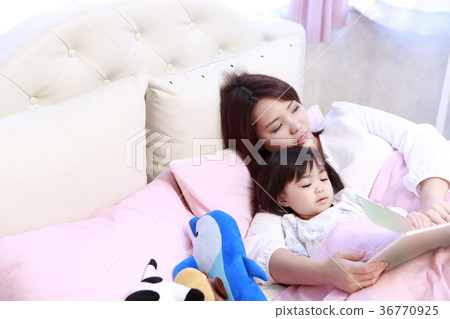 Child having a picture book read in bed Child having a picture book read in bed 36770925