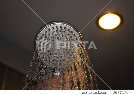 Water flowing from the shower with reflected light 36771764