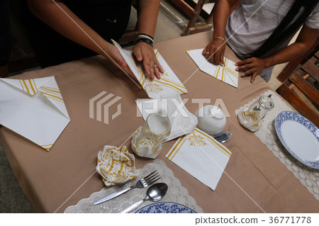 Asian women are practice folding the fabric nepkin 36771778