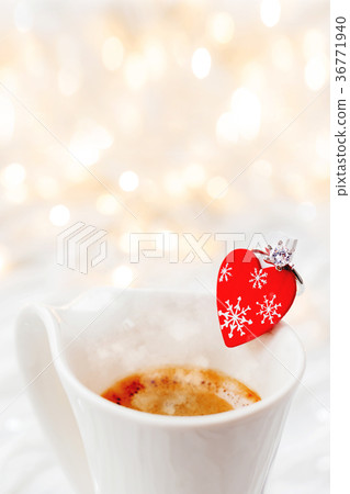 White cup of coffee with decorative heart and ring White cup of coffee with decorative heart and ring 36771940