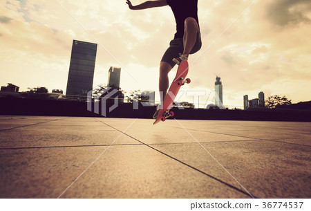 skateboarder skateboarding at sunrise city 36774537