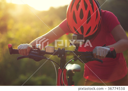 cyclist mount the action camera on mountain bike cyclist mount the action camera on mountain bike 36774538