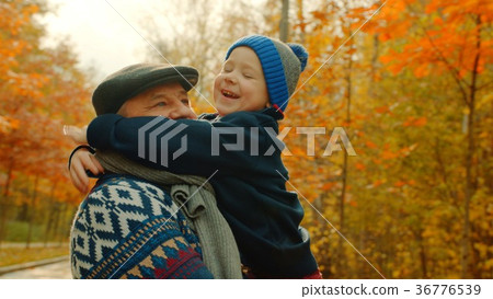 Little happy boy is hugging his grandfather in the Little happy boy is hugging his grandfather in the 36776539