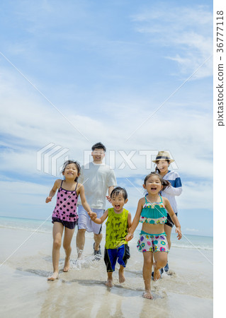 Family of five playing on summer beach 36777118