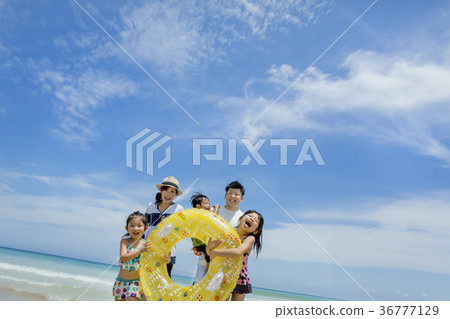 Family of five playing with floats at summer seaside Family of five playing with floats at summer seaside 36777129