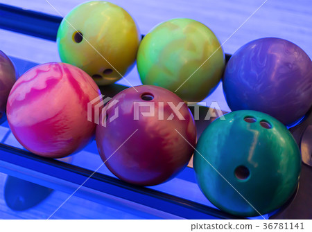 colored bowling ball yellow pink lie in a line 36781141