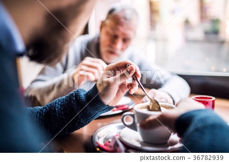 Senior father and his young son in a cafe. 36782939