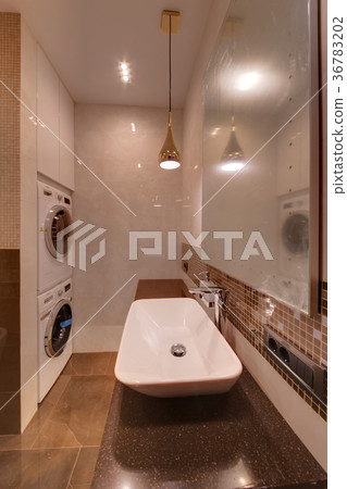 A curbstone with a white sink and a mirror, with w 36783202