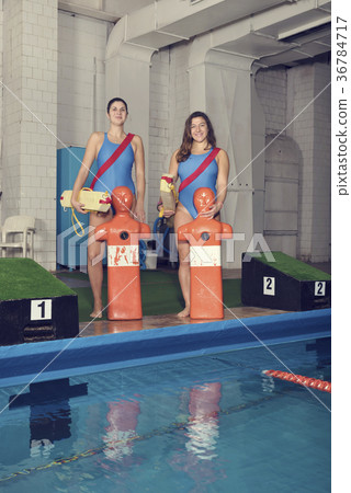 Two Trainers With Training Dummy at a Pool 36784717