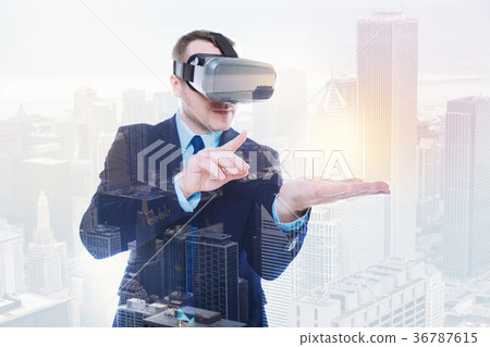 Pleasant businessman interacting with object in 36787615