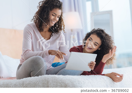 Positive minded girls smiling while looking at 36789002