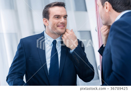 Pleasant cute man touching his head  36789425